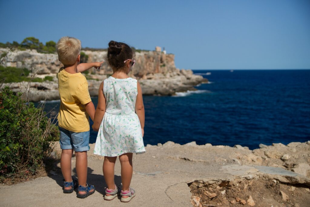 two kids on the cliff on a hot summer day