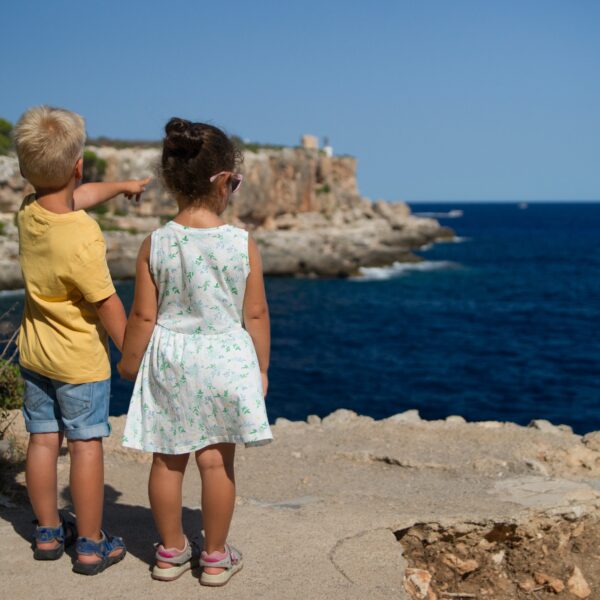 two kids on the cliff on a hot summer day